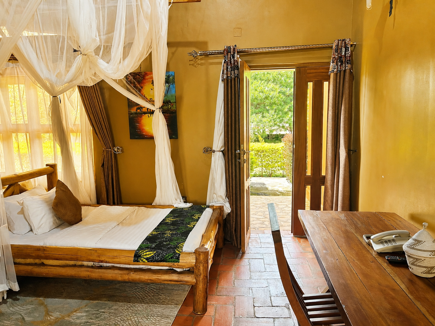 Imhotep banda bedroom with garden door view at Warujojo Safari Lodge