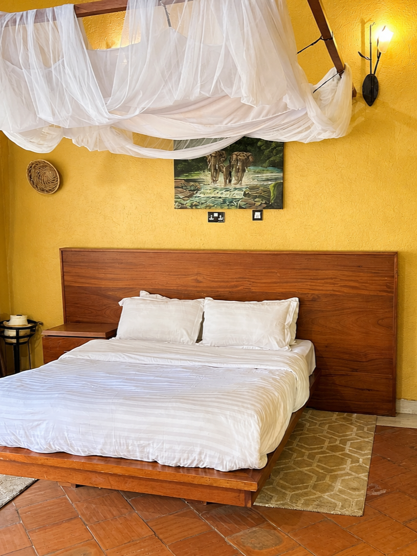 Karakara banda bed with elephant painting, second angle at Warujojo Safari Lodge