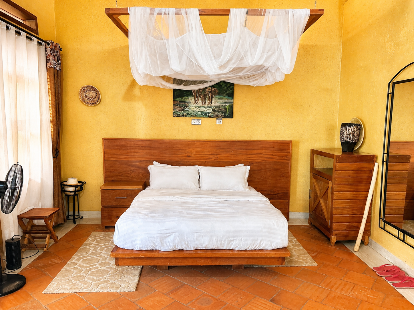 Karakara banda bed with elephant painting at Warujojo Safari Lodge