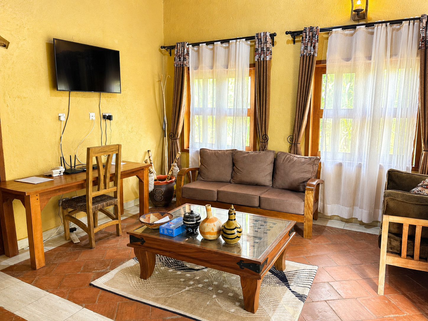 Karakara banda lounge seating and TV area at Warujojo Safari Lodge
