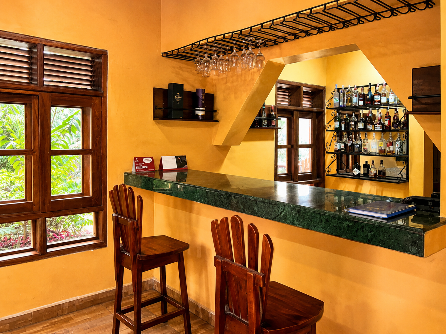Bar counter with timber stools and a stocked back bar at Warujojo Safari Lodge