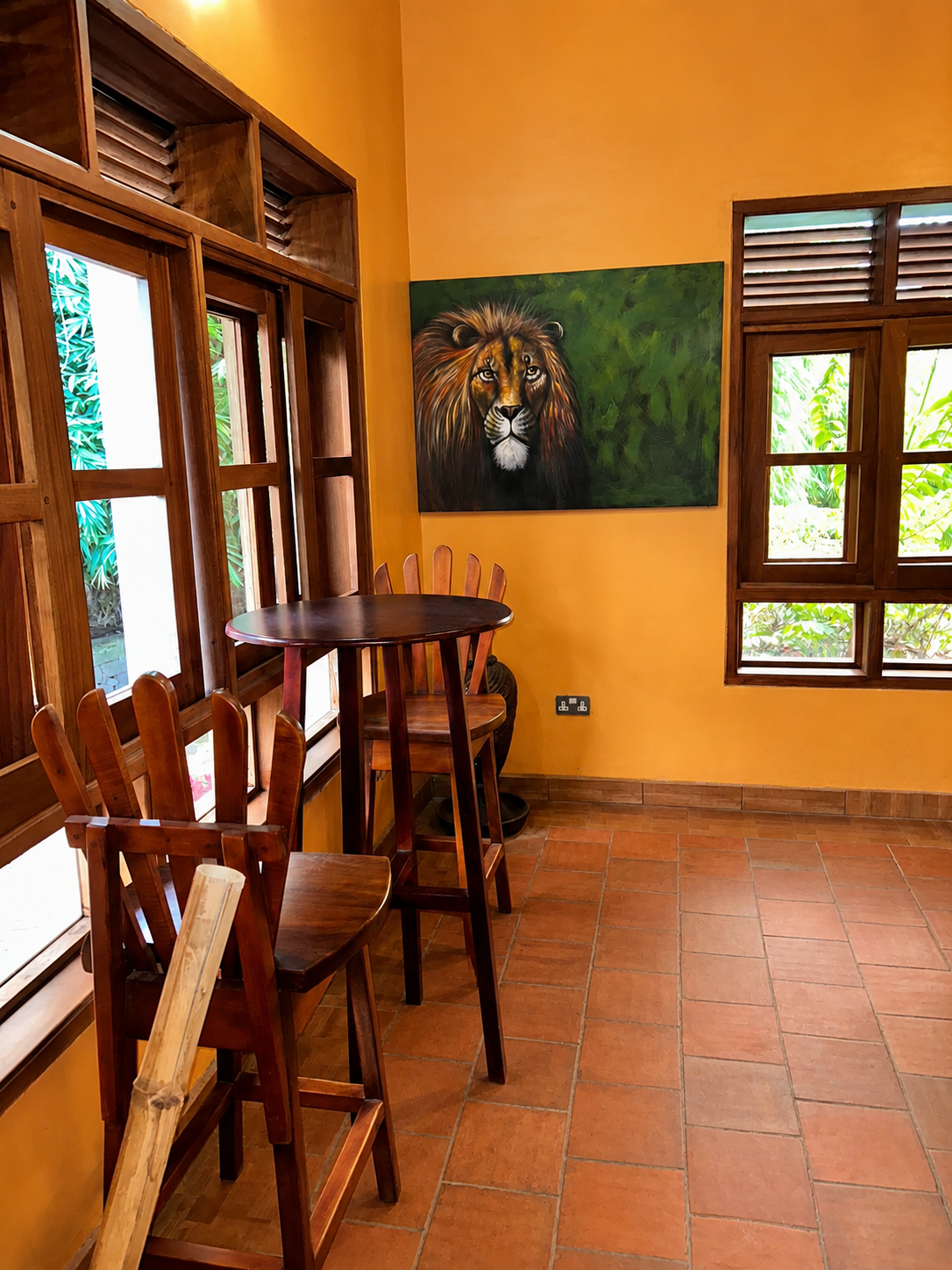 Bar stools by the window looking out to the savanna at Warujojo Safari Lodge