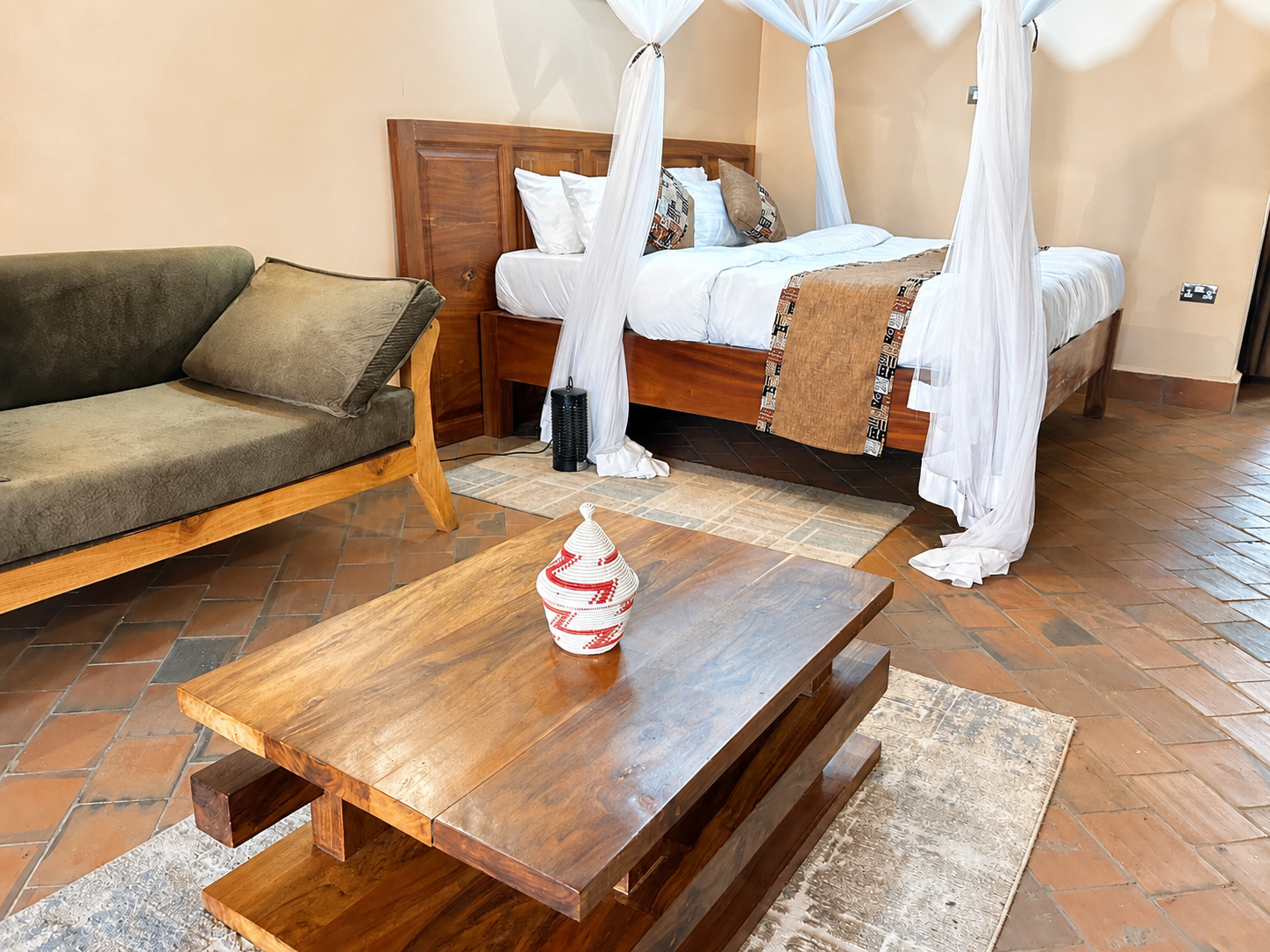 Kibalama cottage lounge sofa and bed view at Warujojo Safari Lodge