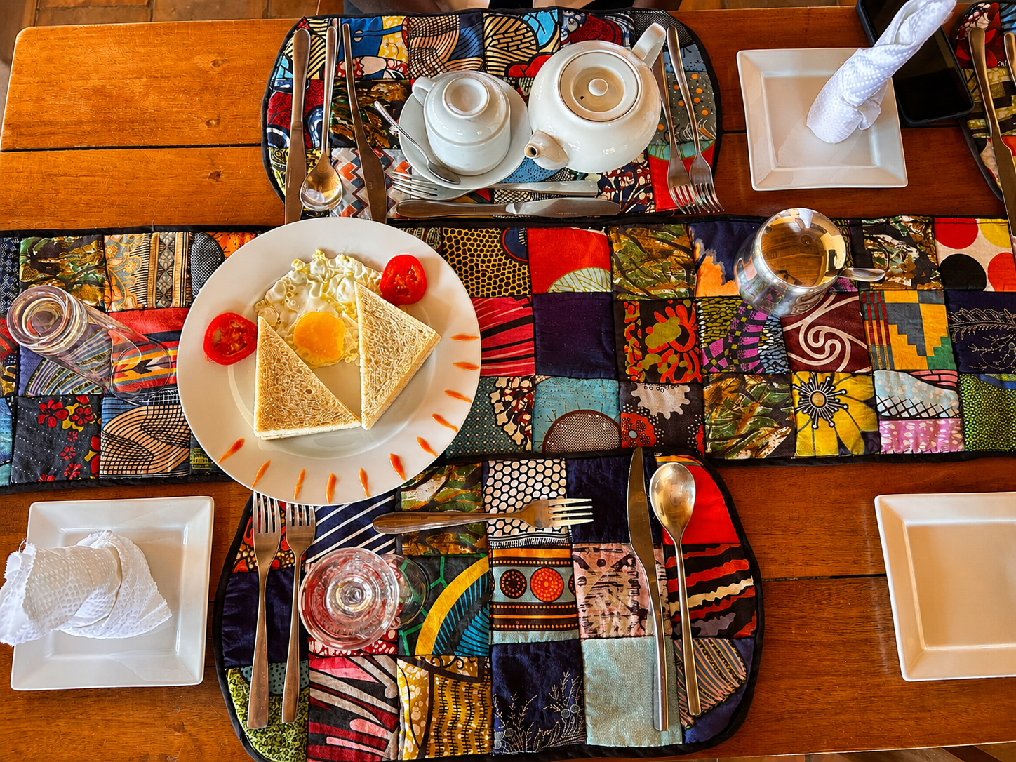 Breakfast laid on hand-printed cloth in the open-air restaurant at Warujojo Safari Lodge