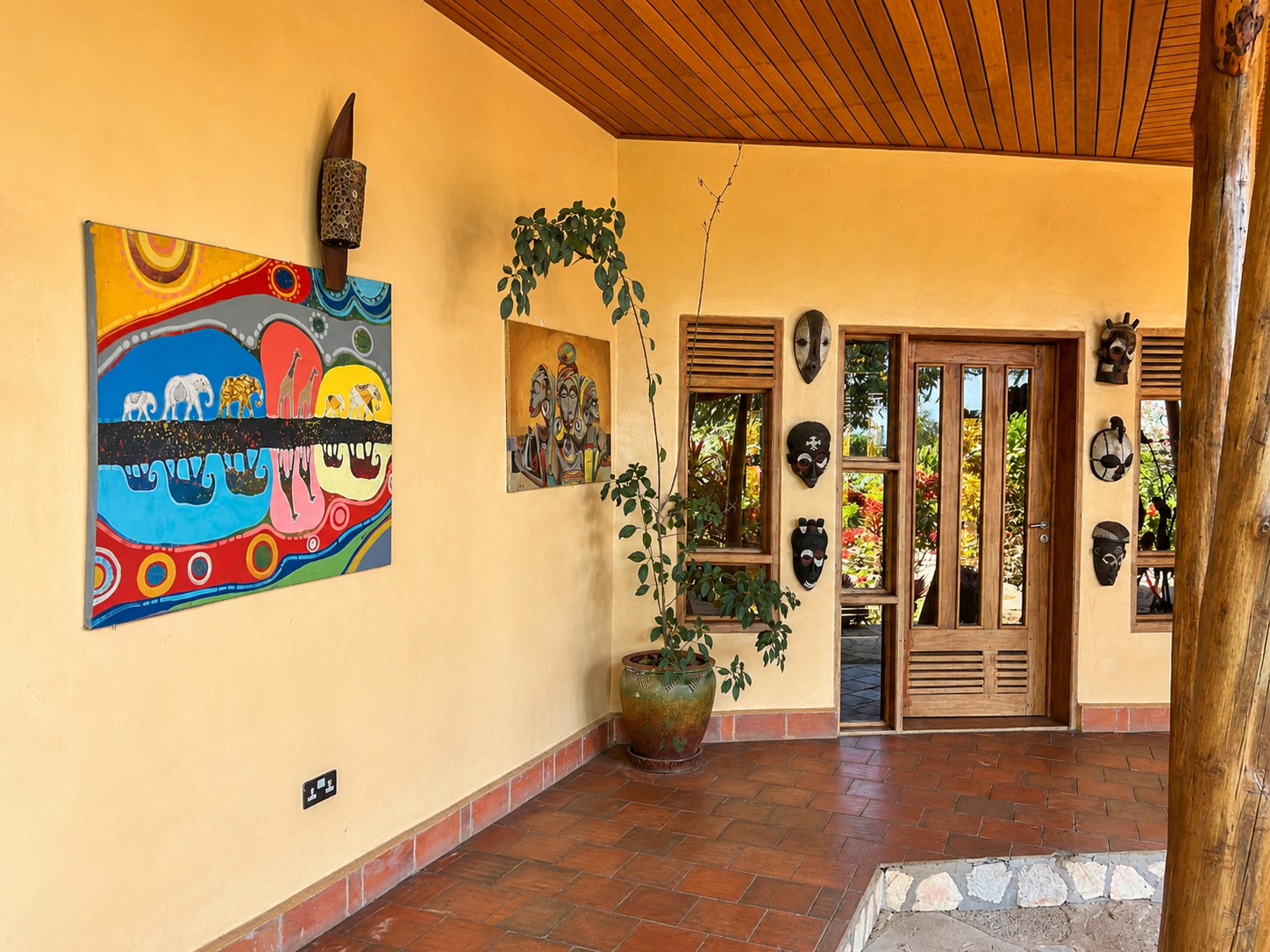 African art and decor along the restaurant entrance hallway at Warujojo Safari Lodge