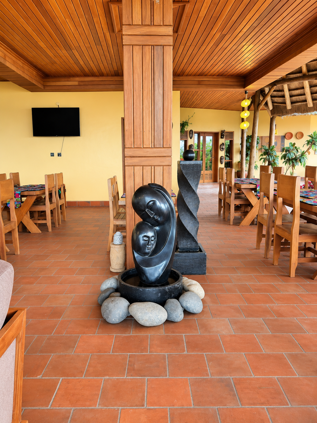 Carved fountain sculpture in the dining hall at Warujojo Safari Lodge