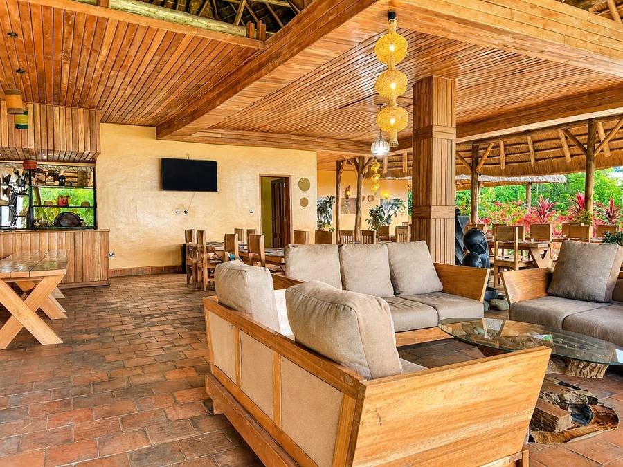 Carved sculpture on the open-air dining terrace at Warujojo Safari Lodge, the plains beyond