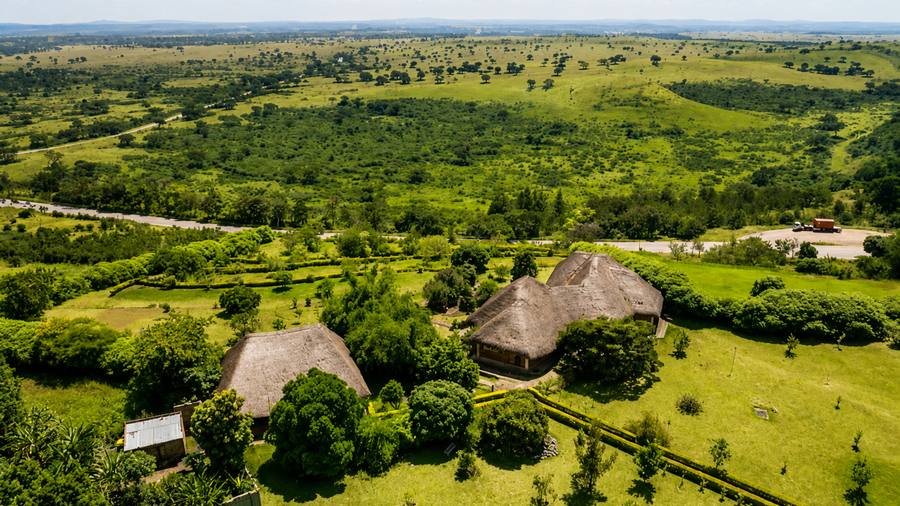 Warujojo Safari Lodge grounds against the savanna plains of Queen Elizabeth National Park