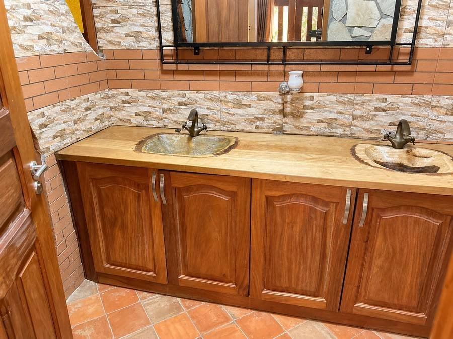 Double timber vanity with hand-carved stone basins in Saraunya banda at Warujojo Safari Lodge